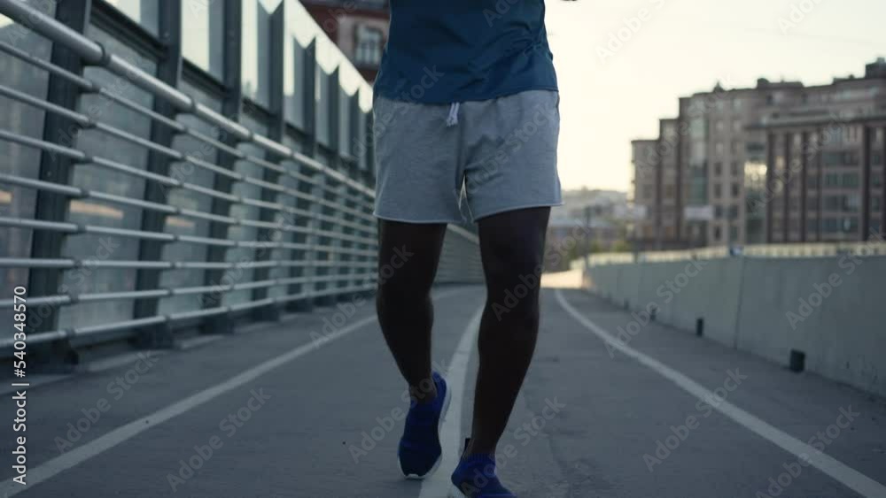 4k Close view of male athlete runs outdoors in city spbas. American African man jogging and doing fit exercise with effort, posing and exercising outdoors in summer. One active black guy running 4k Close view of male athlete runs outdoors in city spbas. American African man jogging and doing fit exercise with effort, posing and exercising outdoors in summer. One active black guy running