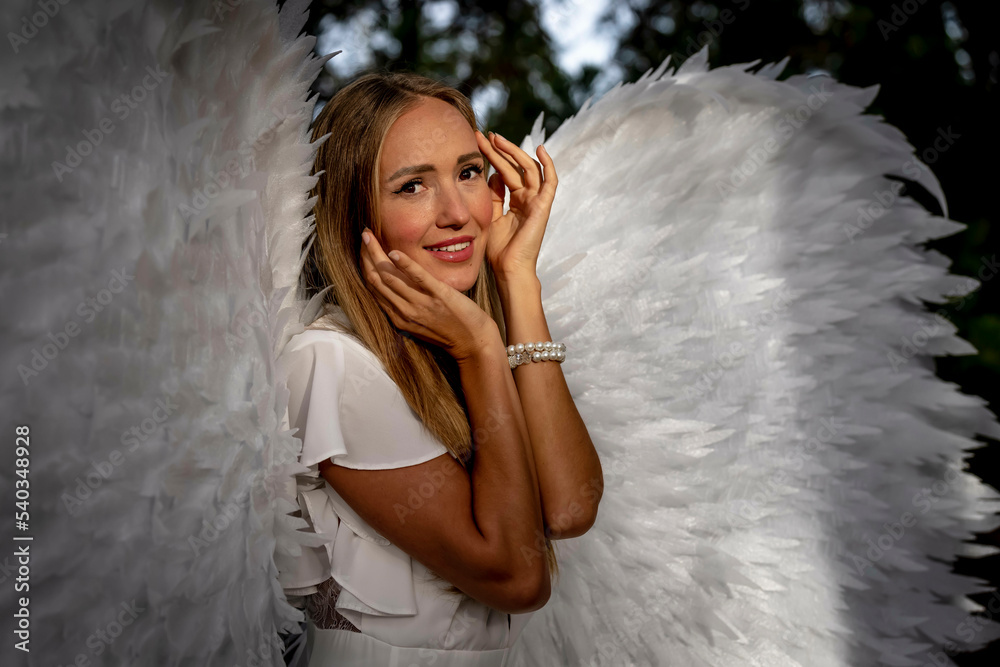 A Lovely Blonde Model Poses Outdoors While Wearing White Handmade Wings For Halloween A Lovely Blonde Model Poses Outdoors While Wearing White Handmade Wings For Halloween
