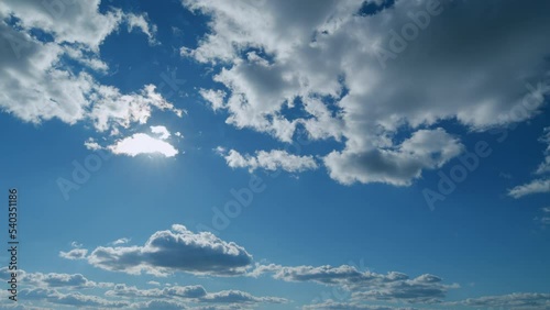 Building clouds and sun rays breaking through cloud mass. Flares shinning through dramatic clouds. Timelapse.