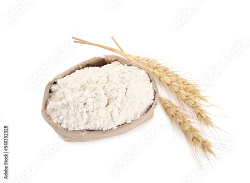 Paper bag with wheat flour and spikes isolated on white, top view