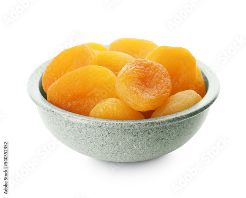 Ceramic bowl with tasty dried apricots isolated on white