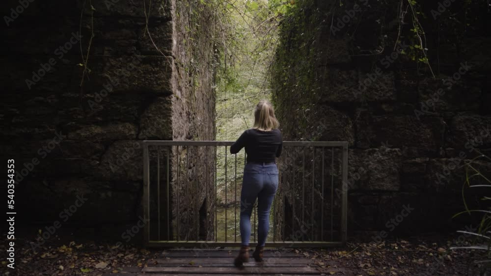 Caucasian Woman In Kennall Vale Nature Reserve Site Of The Old Powder Mills In Ponsanooth, England. Static Shot Caucasian Woman In Kennall Vale Nature Reserve Site Of The Old Powder Mills In Ponsanooth, England. Static Shot