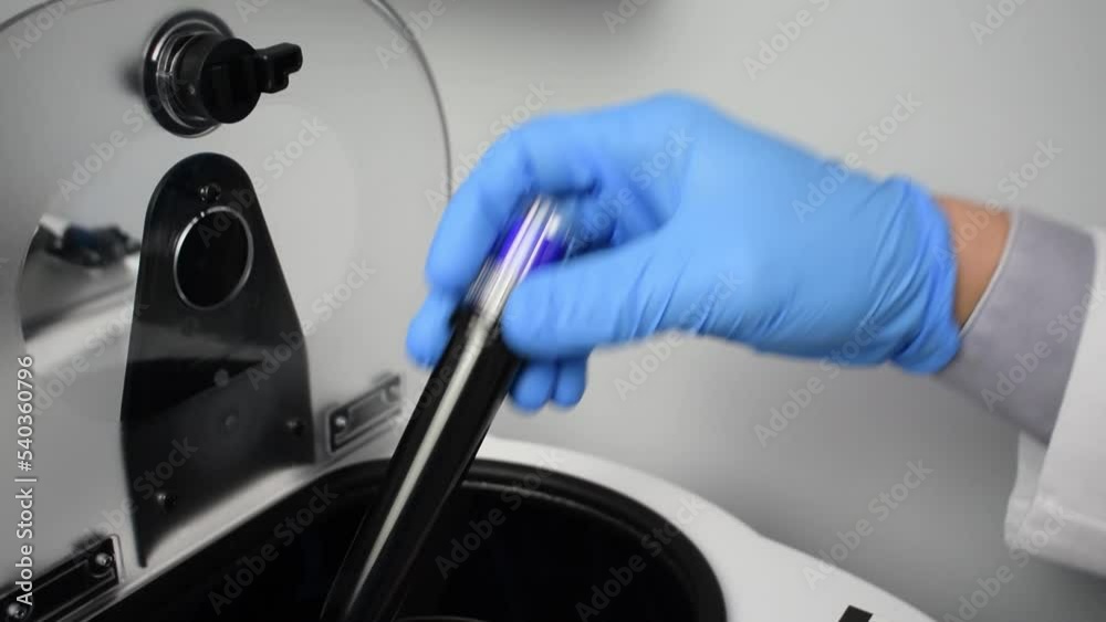 Doctor storing a blood sample in a centrifuge concept of blood