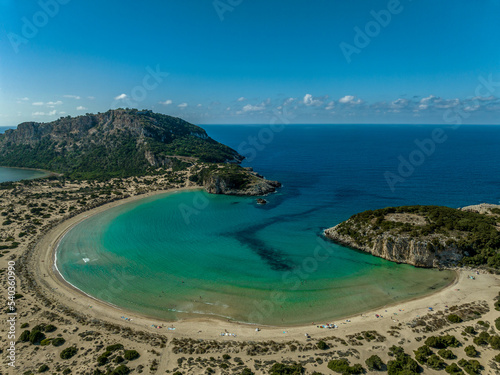 Aerial view of Voidokilia beach near Navarino Greece with crescent shape and turquoise water