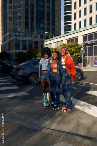 Portrait of young friend group together in the city on rollerskates
