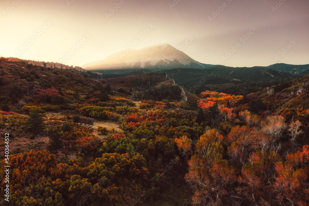 Sun rise glows on the mountain in the fall