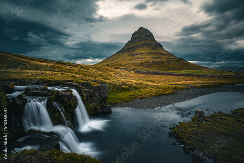 Kirkjufell mountain under dark clouds during sunset with falls
