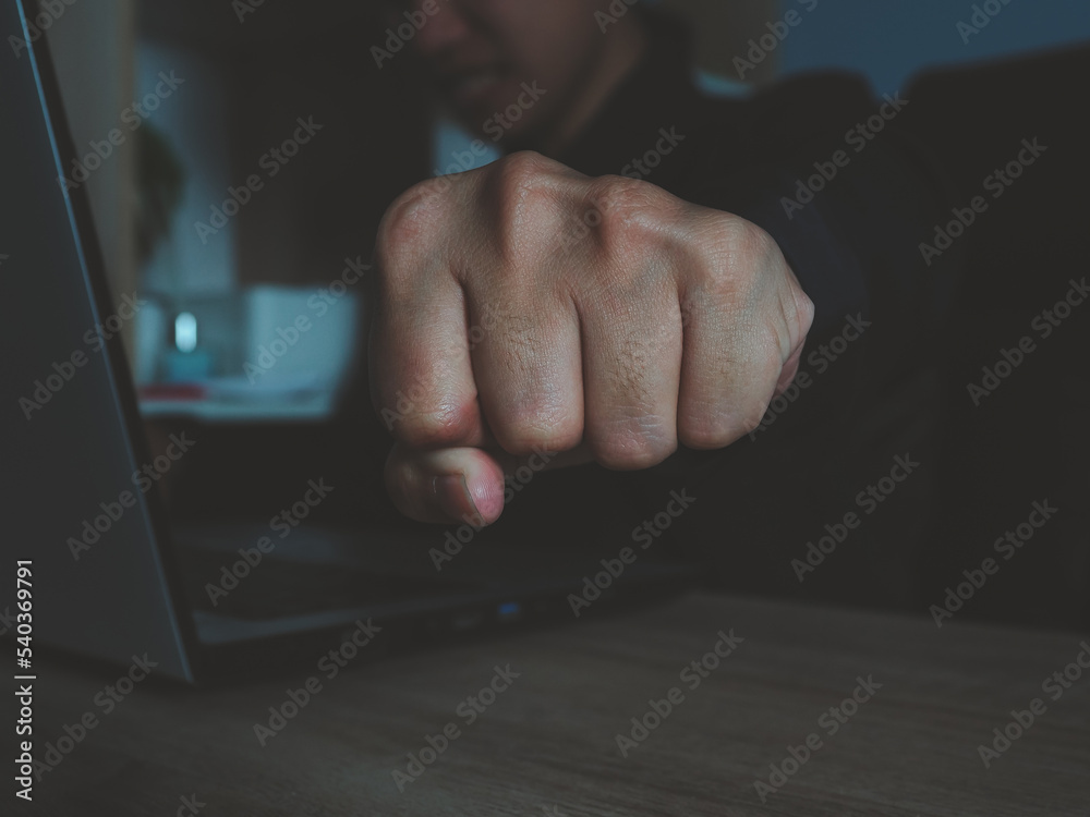 fist punching forward young businessman who is struggling with problems