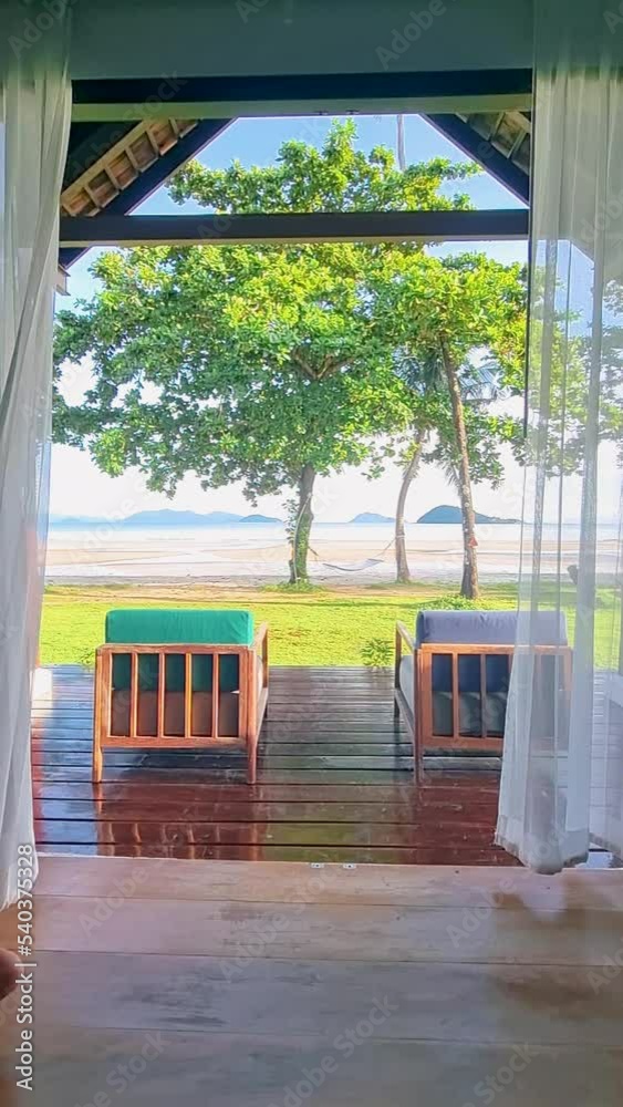 Young men wake up drinking coffee in a beach bungalow on a tropical