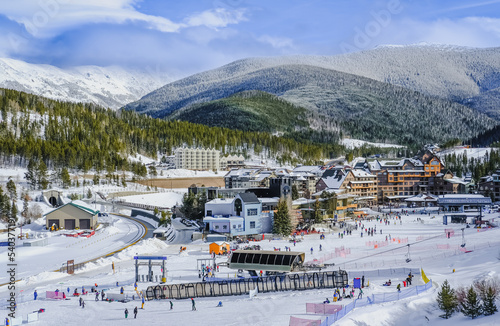 View of base village in Colorado, USA, ski resort on nice winter day; mountains in background