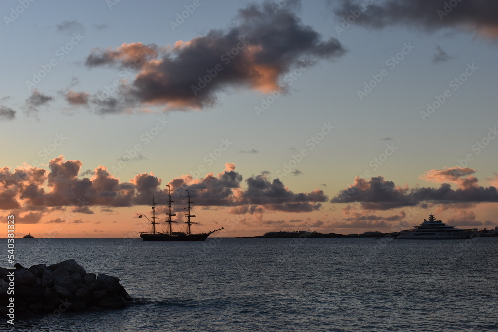 Sunset clouds over the sea and frigate at St. Martin