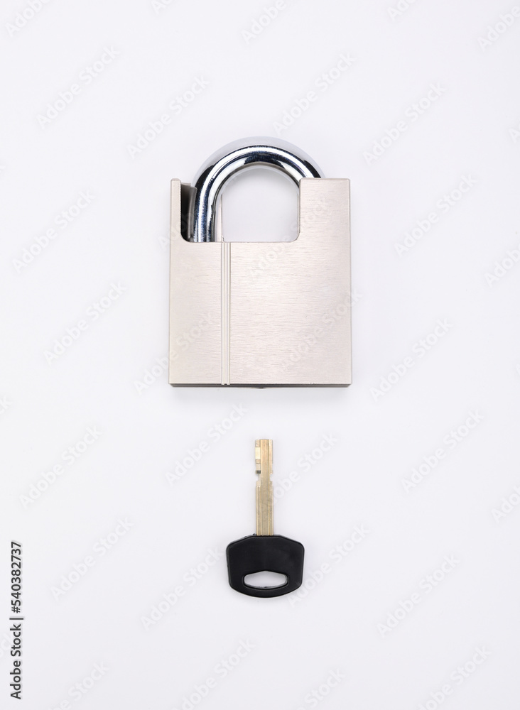 A chrome-plated lock with a key illustrates the key to success. A chrome-plated lock with a key illustrates the key to success.
