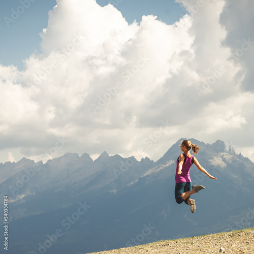 Young woman jumping on the top of the mountains © nickolya