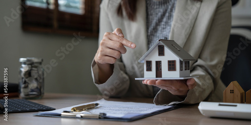 Real estate agent talked about the terms of the home purchase agreement and asked the customer to sign the documents to make the contract legally, Home sales and home insurance concept.