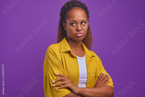 Photography Young shy ethnic African American woman posing with arms crossed in front of che