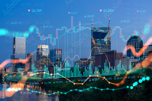 Panoramic view of Broadway district of Nashville over the river at illuminated night skyline, Tennessee, USA. Forex candlestick graph hologram. The concept of internet trading, brokerage and analysis