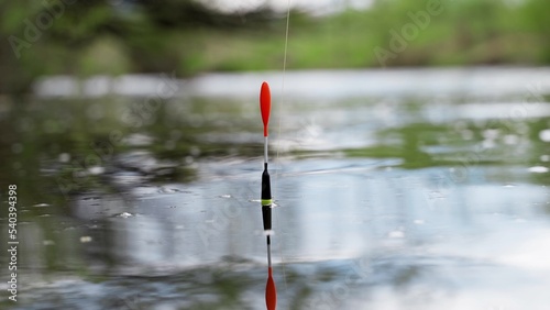 Fishing on a river or lake. The float is moving in the waves. Fish grabs bait © filin174