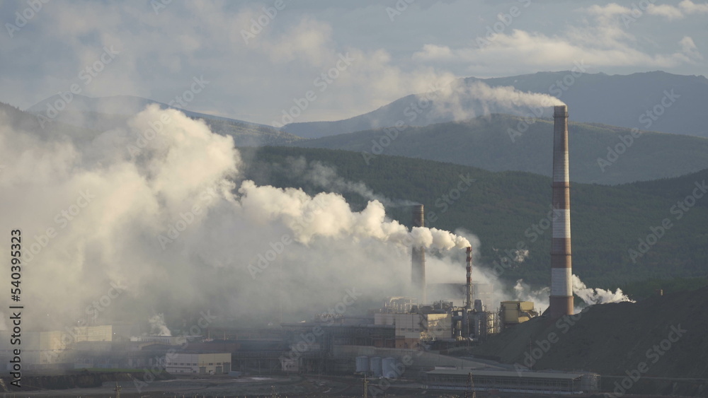 Industry pipes pollute the atmosphere with smoke