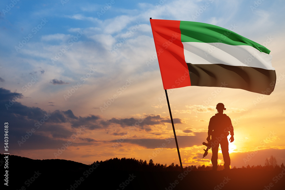 silhouette-of-soldier-with-the-flag-of-uae-against-sunset-or-sunrise