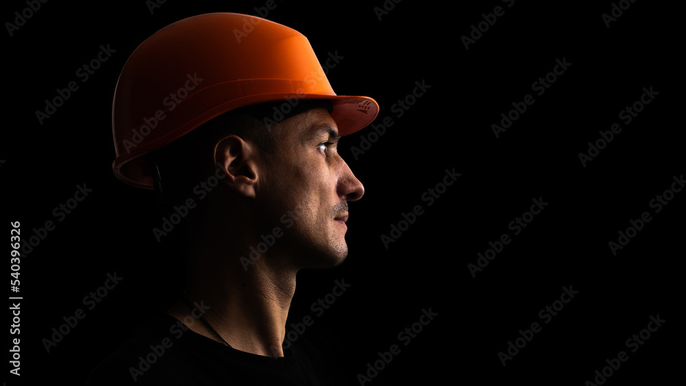 Dirty face of coal miner on a black background. Head of tired mine worker in a hard hat. Dirty face of coal miner on a black background. Head of tired mine worker in a hard hat.