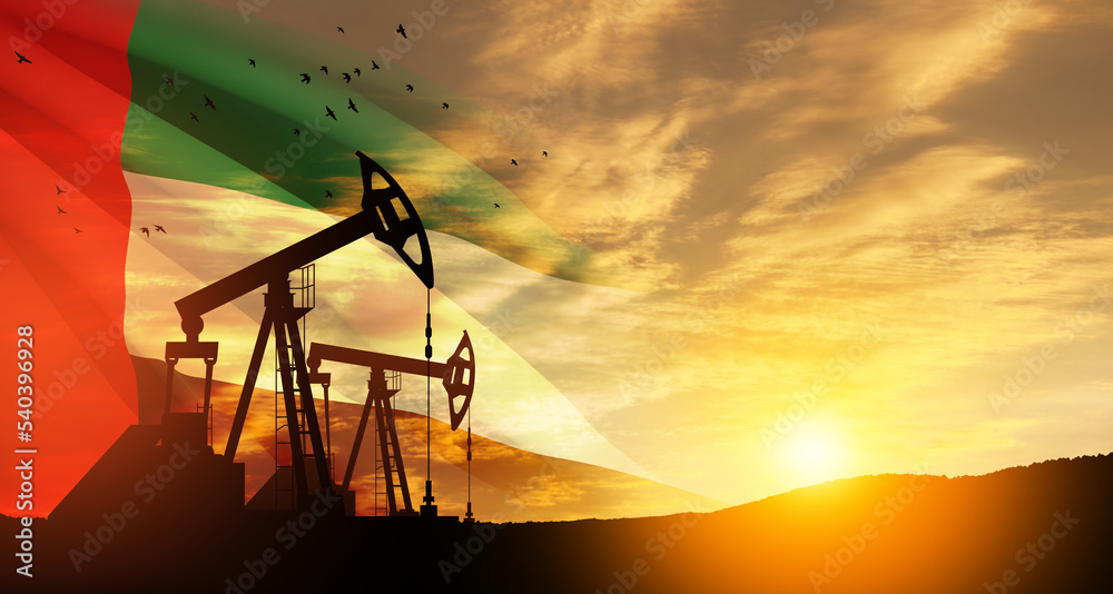 Fototapeta premium The change in oil prices caused by the war. Oil prices are rising because of the global crisis. Oil drilling derricks at desert oilfield with UAE flag. Crude oil production from the ground.