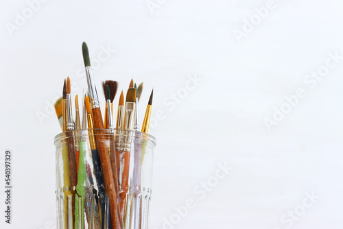 Fototapeta Naklejka Na Ścianę i Meble -  paint brushes in jar over white background. vintage filtered image