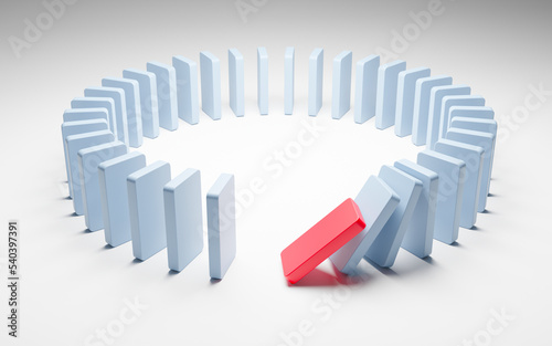 Domino effect. Dominoes placed in a circle and falling photo