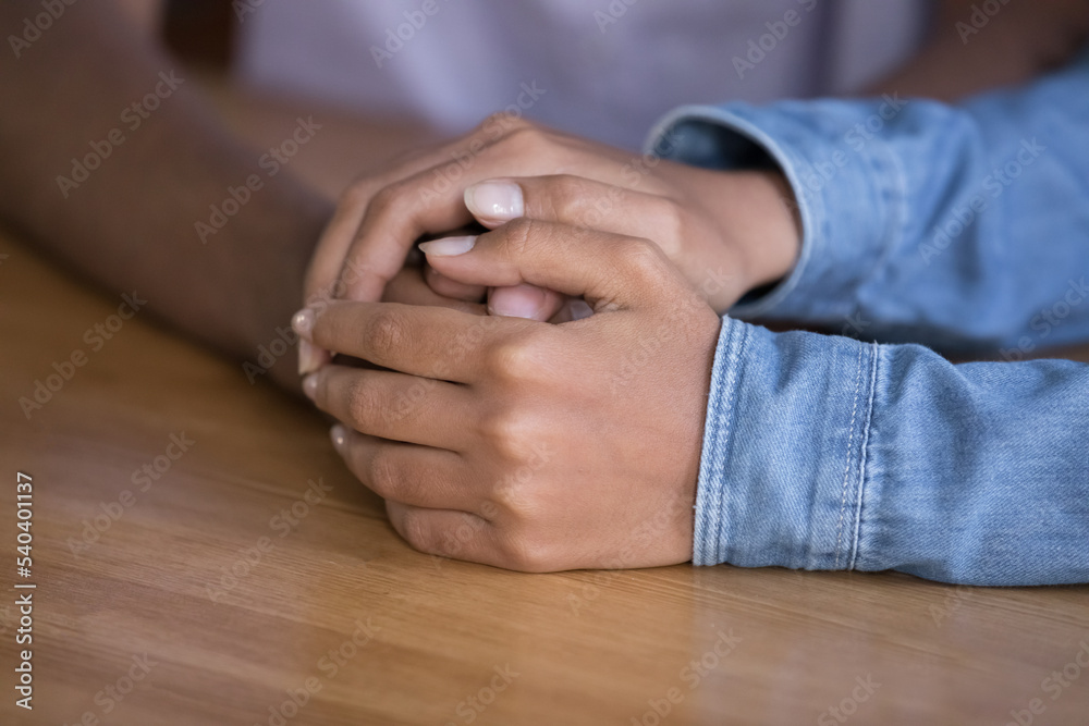 Obraz premium Loving girlfriend touches hand of beloved boyfriend, give psychological support, express love, care in difficult life situation, close up arms of unknown African couple. Compassion, help, togetherness