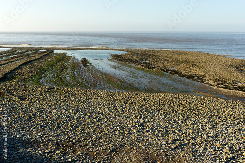 Stones and slabs at low tide on Lilstock beach, Somerset. photo