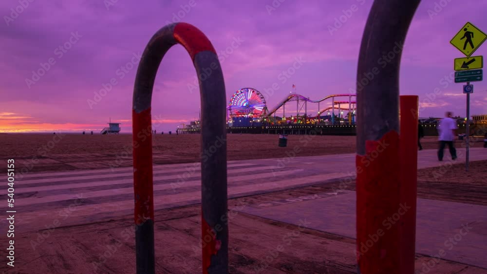 Time Lapse Shot Of People Enjoying Festival At Beach With Illuminated Amusement Park In Background From Sunset To Night - Santa Monica, California Time Lapse Shot Of People Enjoying Festival At Beach With Illuminated Amusement Park In Background From Sunset To Night - Santa Monica, California
