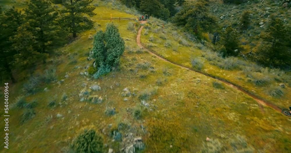 Aerial Backward Shot Of Man Riding Mountain Bike On Dirt Road - White Ranch Park, Colorado Aerial Backward Shot Of Man Riding Mountain Bike On Dirt Road - White Ranch Park, Colorado