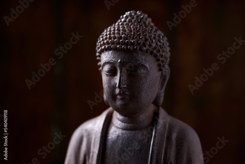 Meditating Buddha Statue on dark background. Soft focus. Close up. Copy space.                                                                © Eugeniusz Dudziński