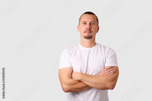 Portrait of a strong man posing on white background