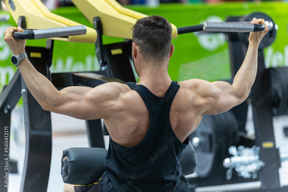 Fitness Workout: Boy doing Exercises in Class with Shoulder Gym Equipment Fitness Workout: Boy doing Exercises in Class with Shoulder Gym Equipment