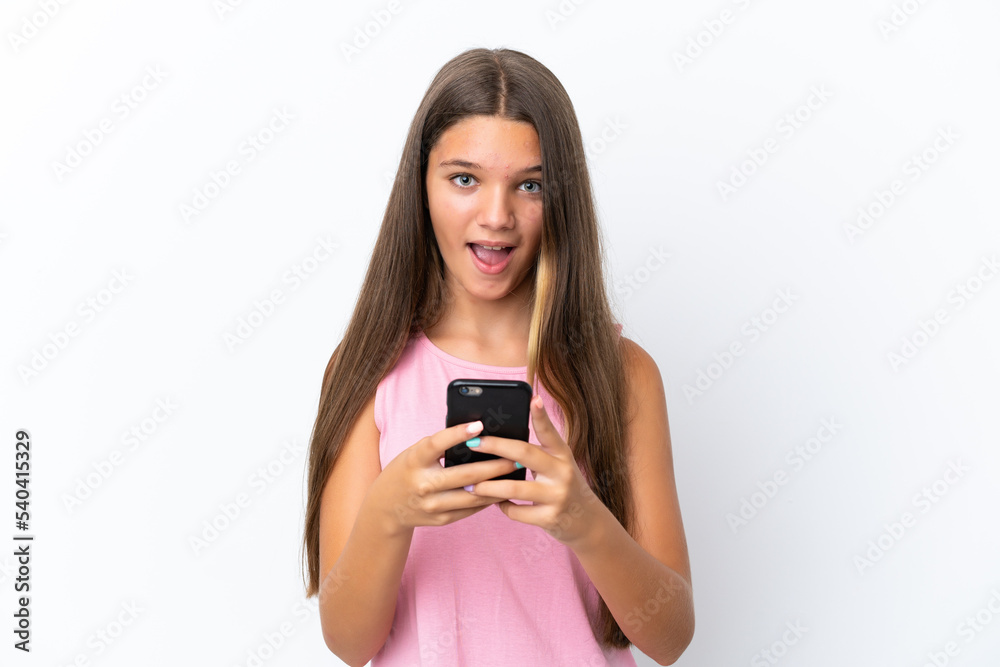 Little caucasian girl isolated on white background surprised and sending a message Little caucasian girl isolated on white background surprised and sending a message