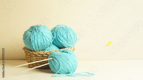 turquoise skeins of yarn and knitting needles