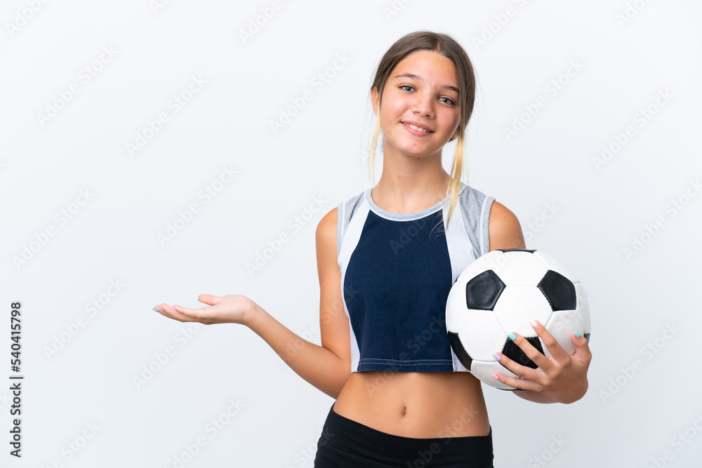 Little caucasian girl playing football isolated on white background extending hands to the side for inviting to come