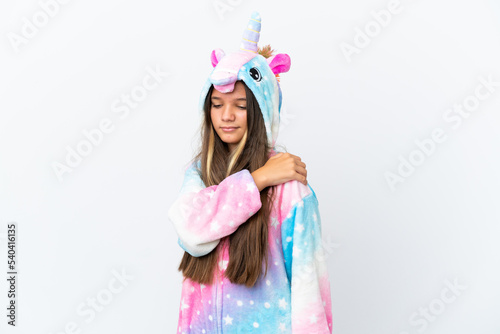 Little caucasian girl wearing unicorn pajama isolated on white background suffering from pain in shoulder for having made an effort