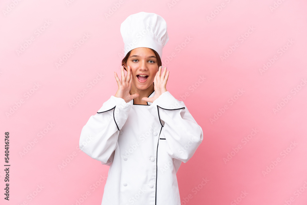Little caucasian chef girl isolated on pink background shouting and announcing something Little caucasian chef girl isolated on pink background shouting and announcing something