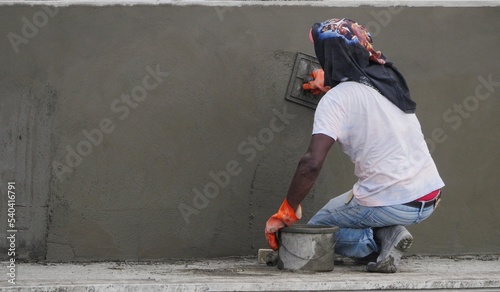 Builder parging wall with cement paste photo