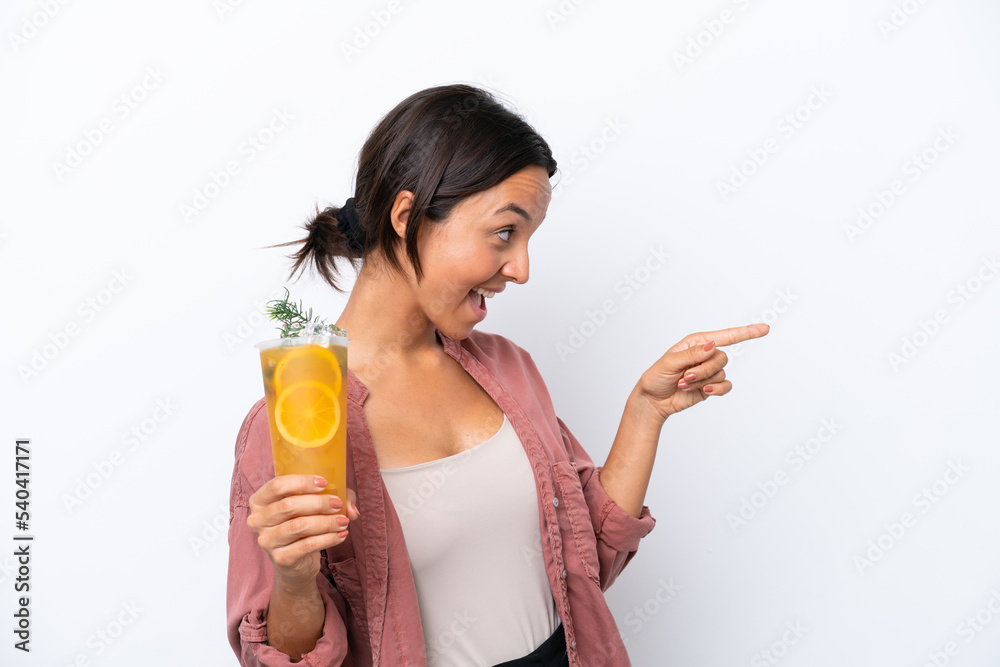Young hispanic woman holding a cocktail isolated on white background pointing finger to the side and presenting a product