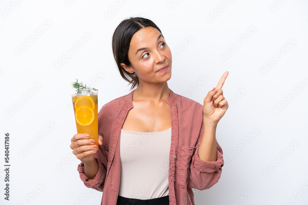 Young hispanic woman holding a cocktail isolated on white background pointing up a great idea Young hispanic woman holding a cocktail isolated on white background pointing up a great idea