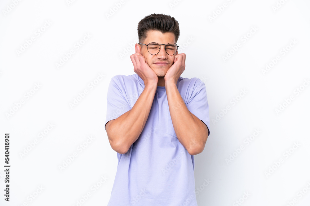 Young caucasian man isolated on white background frustrated and covering ears