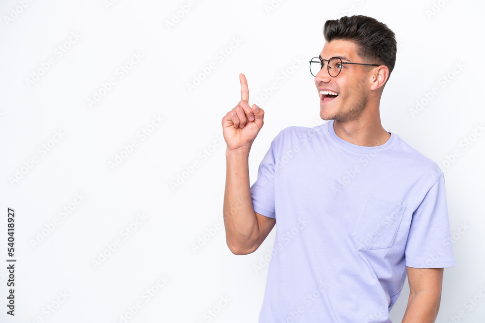 Young caucasian man isolated on white background intending to realizes the solution while lifting a finger up Young caucasian man isolated on white background intending to realizes the solution while lifting a finger up