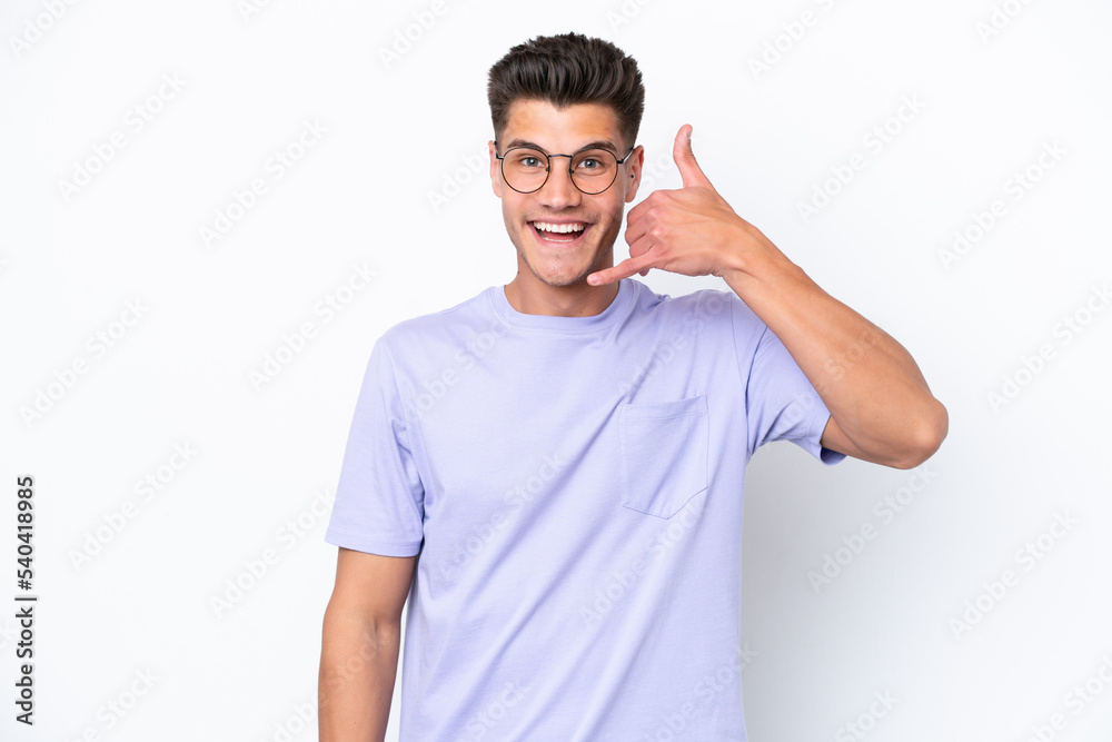 Young caucasian man isolated on white background making phone gesture. Call me back sign Young caucasian man isolated on white background making phone gesture. Call me back sign