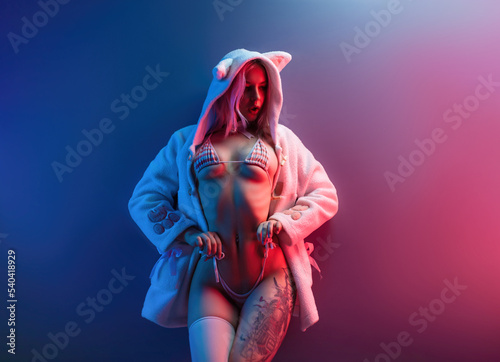 sexy girl in underwear in neon lights on a uniform neon background place copy paste