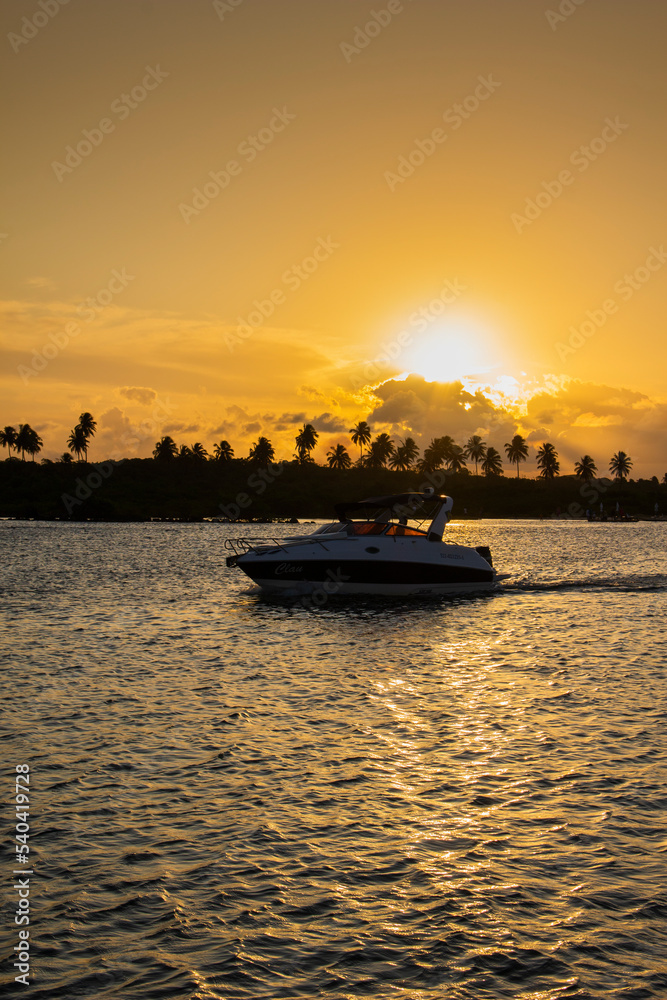 Naklejka premium People have fun at brazilian sunrise beach on October, 2022, Porto de Galinhas, Brazil.
