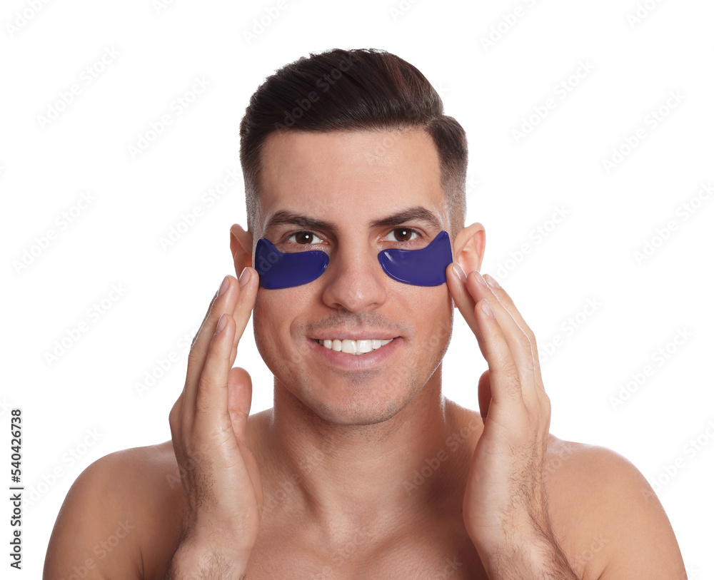 Fototapeta premium Man applying blue under eye patch on white background