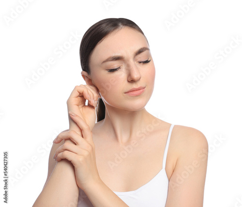 Young woman suffering from ear pain on white background