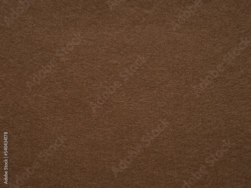 Dark brown felt, velvet texture. Soft background for text, lettering, patchworkor other art work. Full frame backdrop pattern wallpaper of art and stationery material in dark color. Natural felt.